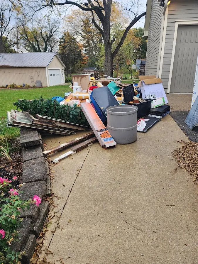 Dumpster being loaded with debris for 3 Yard Dumpster Rental in Greenville